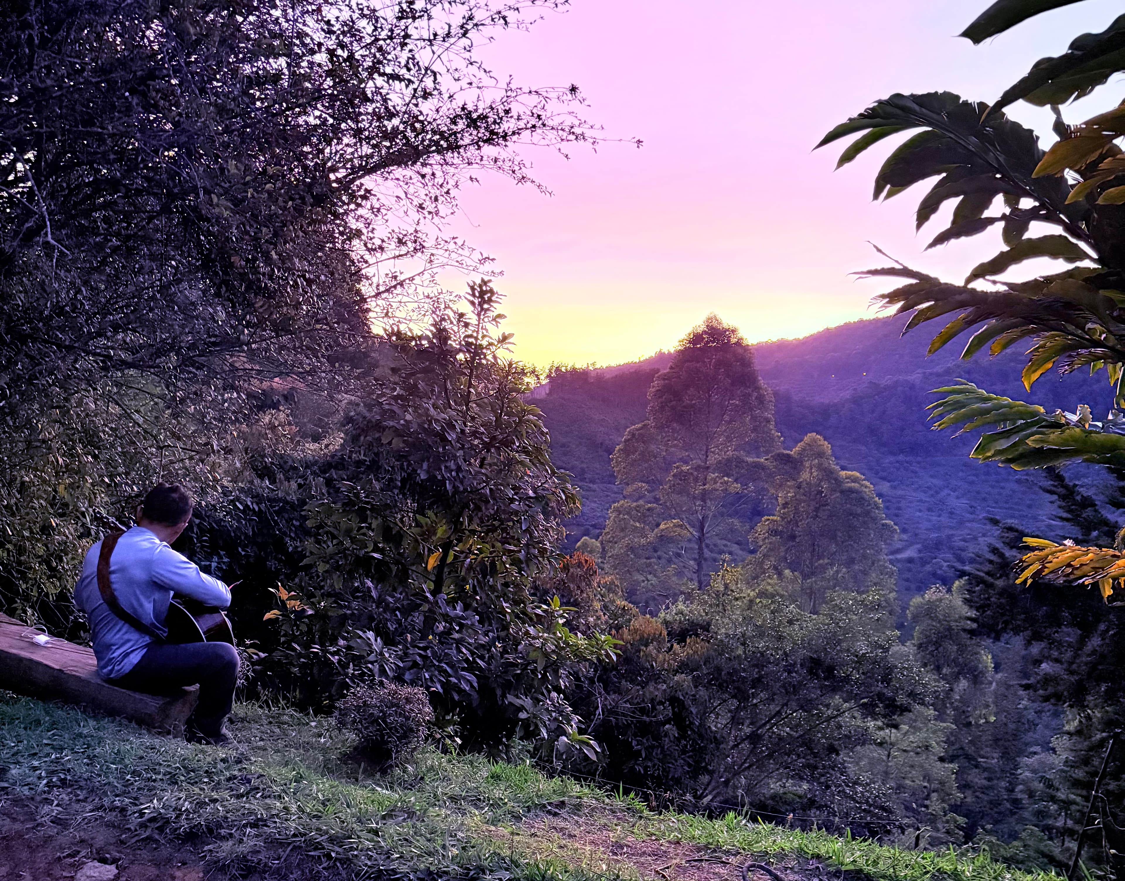 Peaceful sunset view over the Antioquia mountains with a guest playing guitar